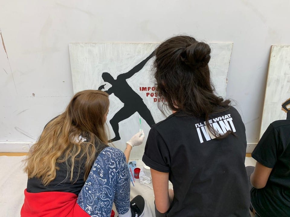 A team of young people creating a wall murals